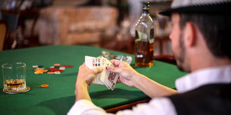 The man is studying how to play Blackjack card game